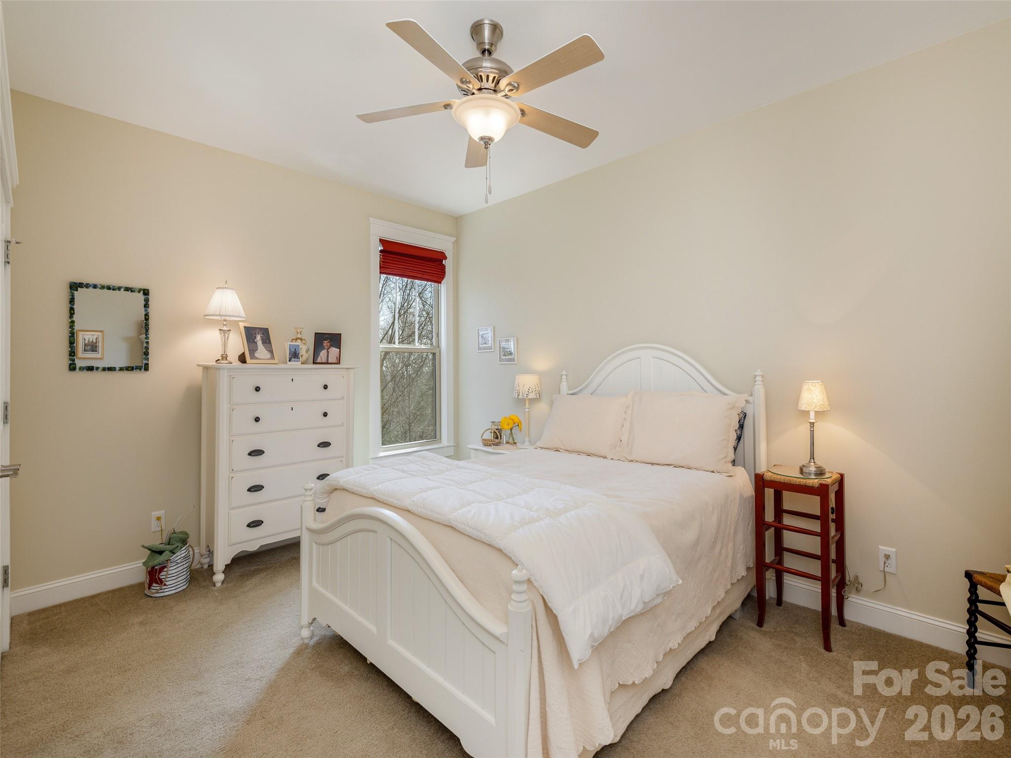 383 Monarch Road Hendersonville, NC 28739 - Photo 30 of 48 a bedroom with a bed and a chandelier