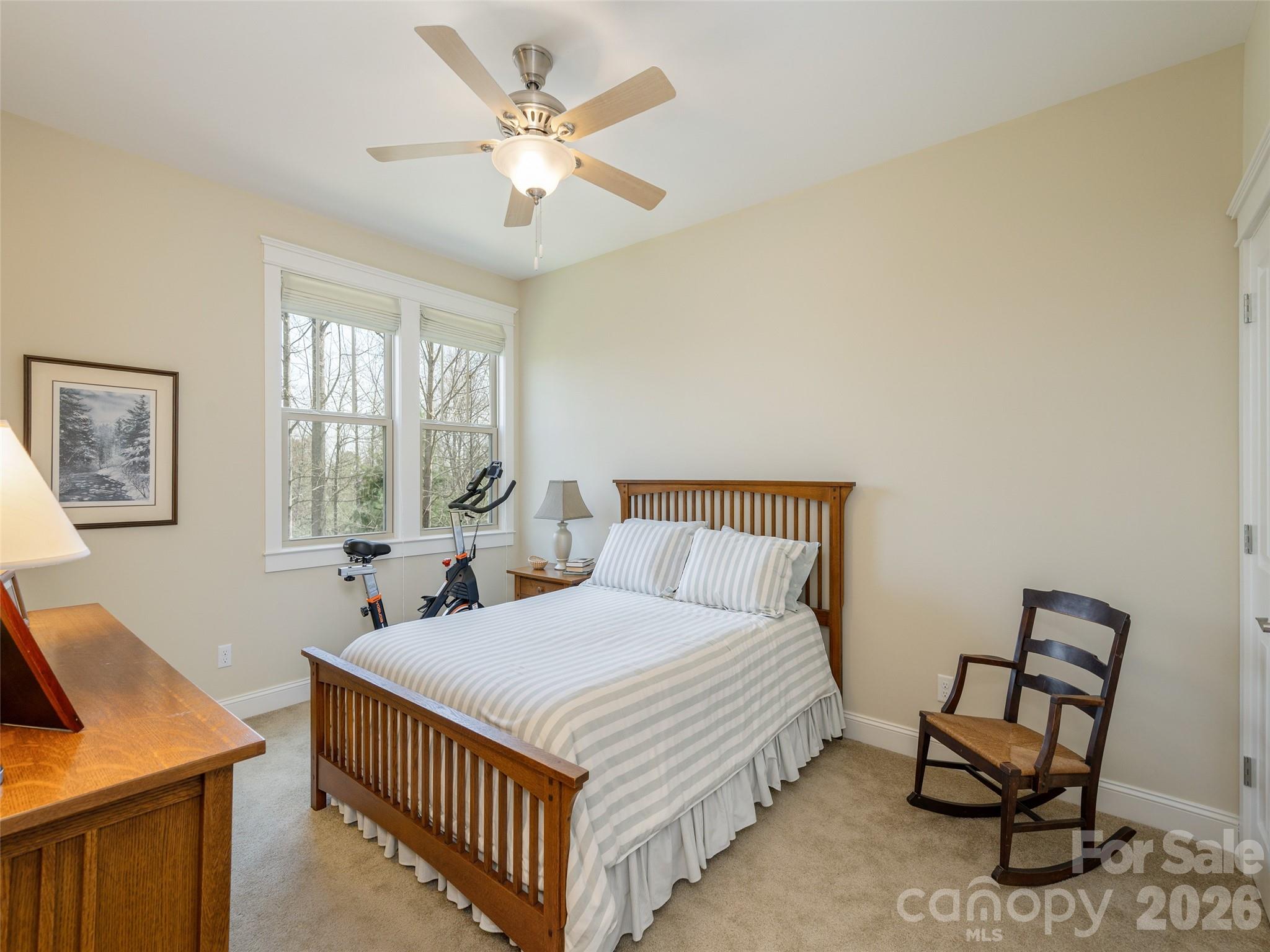 383 Monarch Road Hendersonville, NC 28739 - Photo 39 of 48 a bedroom with a bed a table and chair