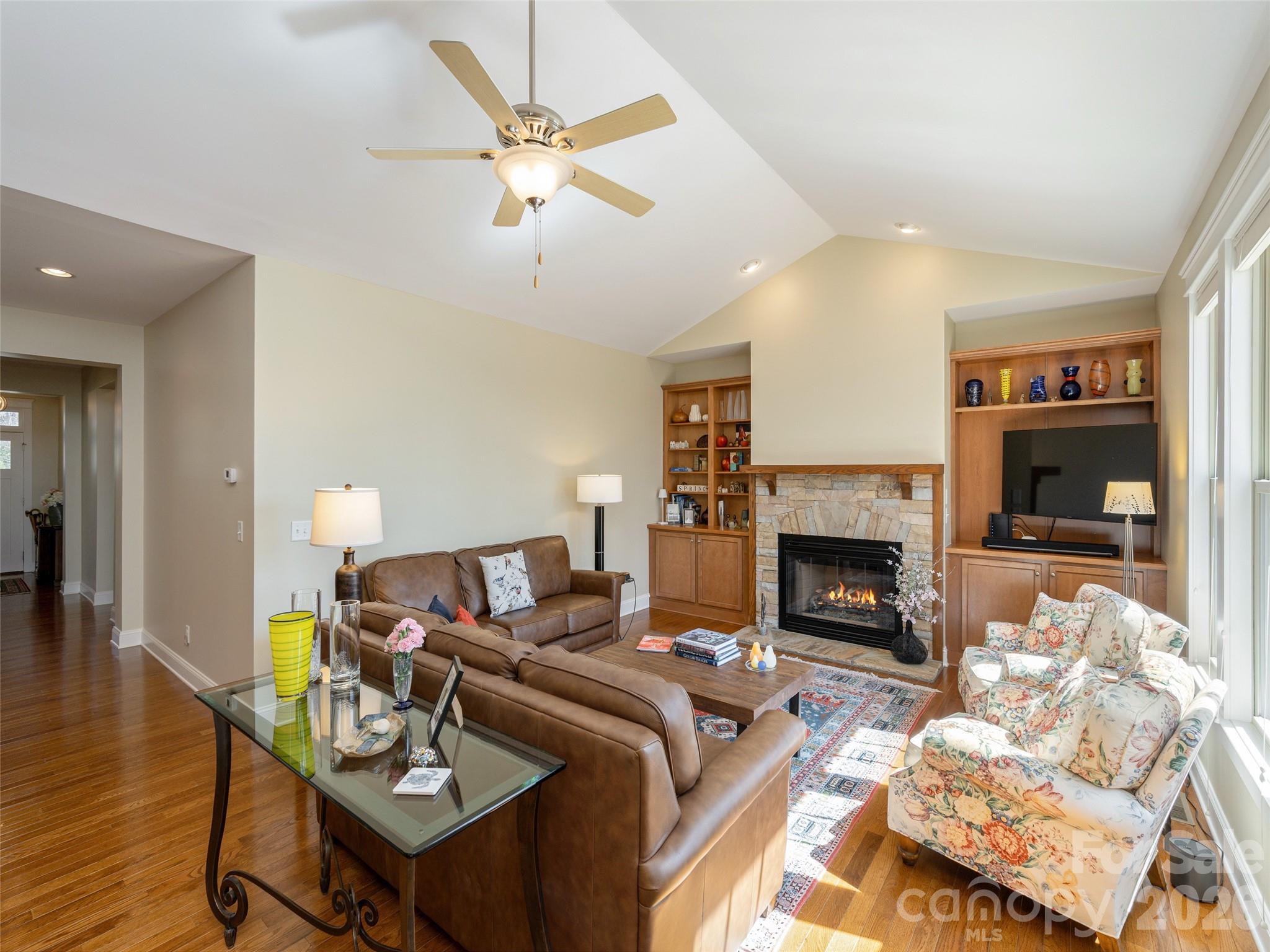 383 Monarch Road Hendersonville, NC 28739 - Photo 8 of 48 a living room with furniture a fireplace and a flat screen tv