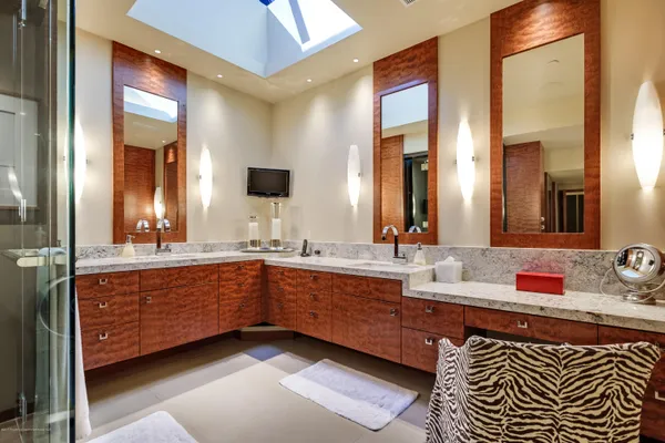 a bathroom with double vanity and a mirror