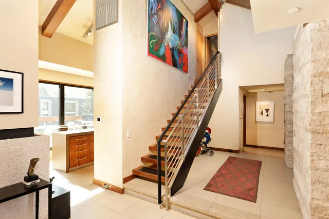 a bedroom with a bed and a tv on the dresser