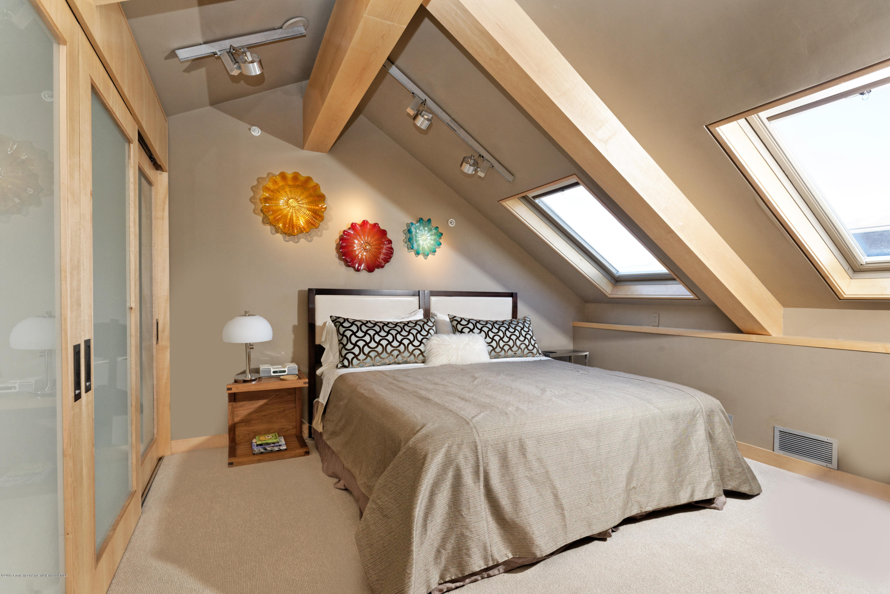 710 East Durant Avenue, Unit C & D Aspen, CO 81611 - Photo 20 of 23 a bedroom with a bed and a window