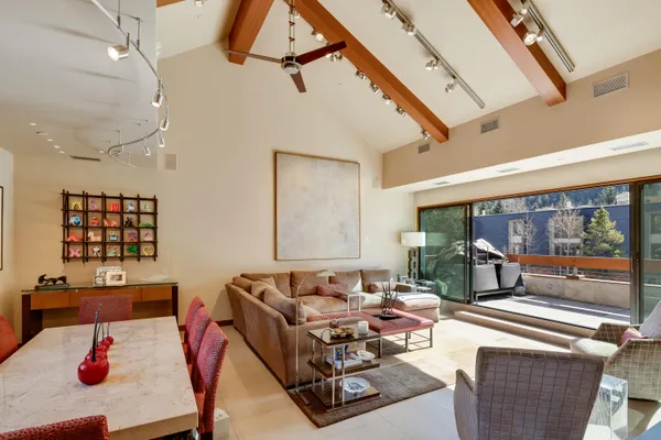 a living room with furniture and a floor to ceiling window