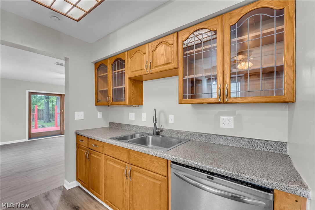 18517 Homeway Road Cleveland, OH 44135 - Photo 11 of 29 Kitchen featuring wood cabinetry, speckled countertops, and a double basin sink with a gooseneck faucet