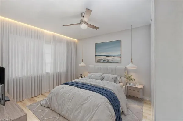 a bedroom with a bed and a lamp