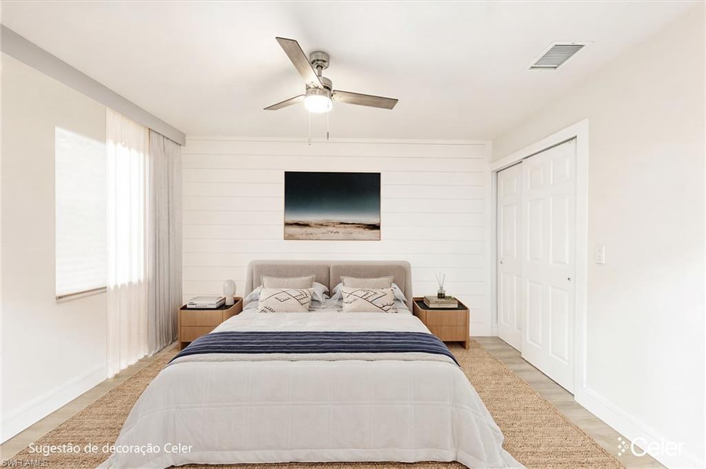 5 Watercolor Way, Unit 5 Naples, FL 34113 - Photo 6 of 13 a bedroom with a bed and wooden floor