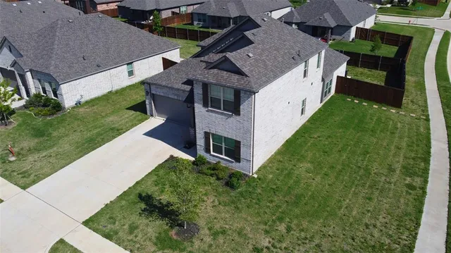an aerial view of a house with a yard