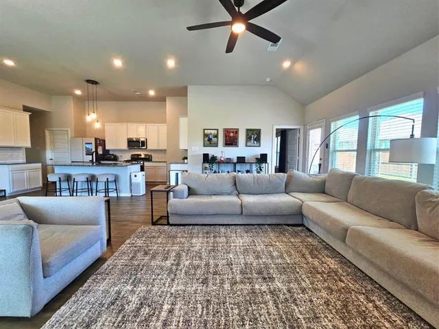 a living room with furniture and a rug