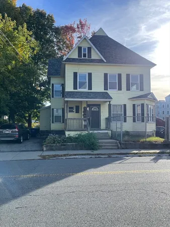 a front view of a house with a yard
