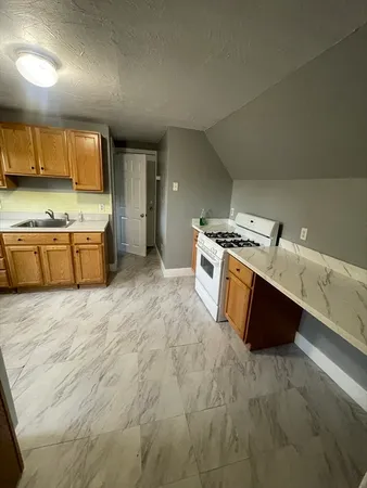 a kitchen with stainless steel appliances granite countertop a stove a sink dishwasher and a oven