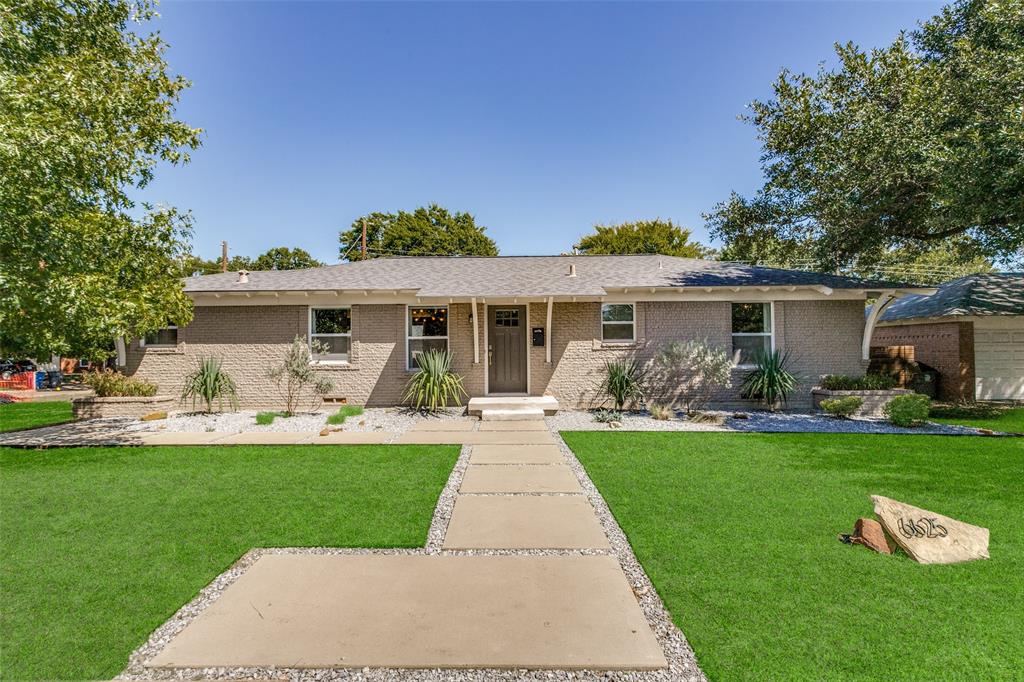 a front view of house with a garden and patio