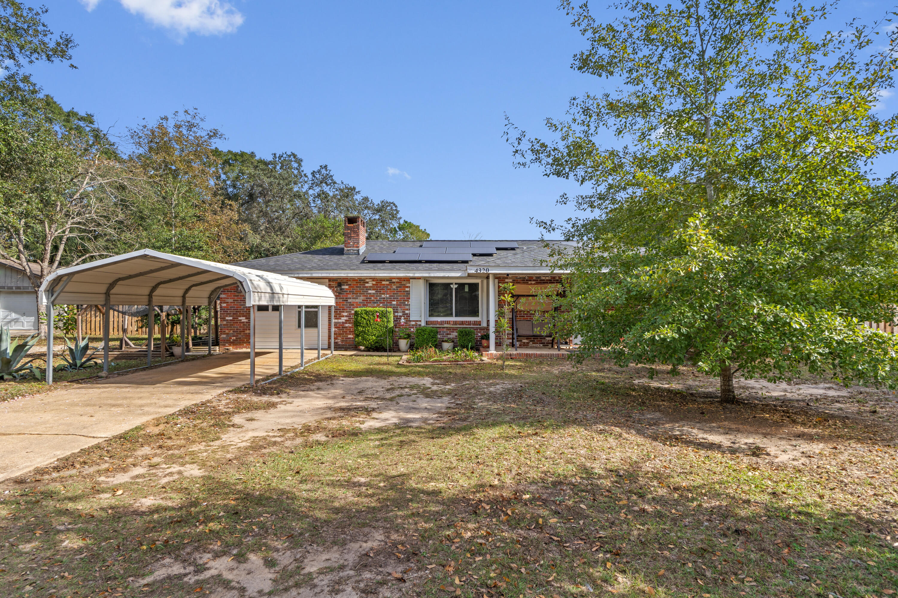 a front view of a house with a yard and trees