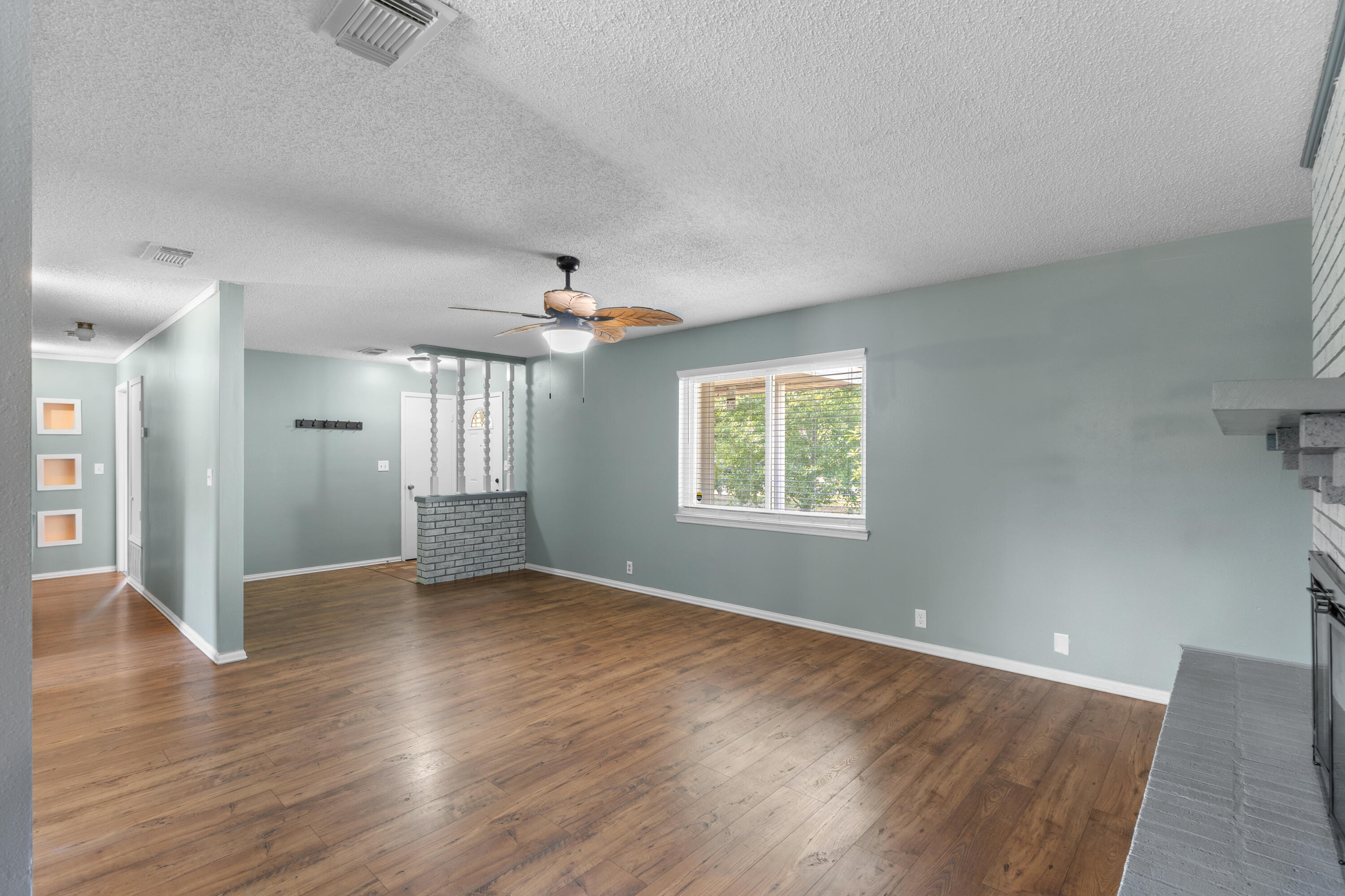 4320 Reinsma Road Milton, FL 32583 - Photo 12 of 41 an empty room with wooden floor and windows