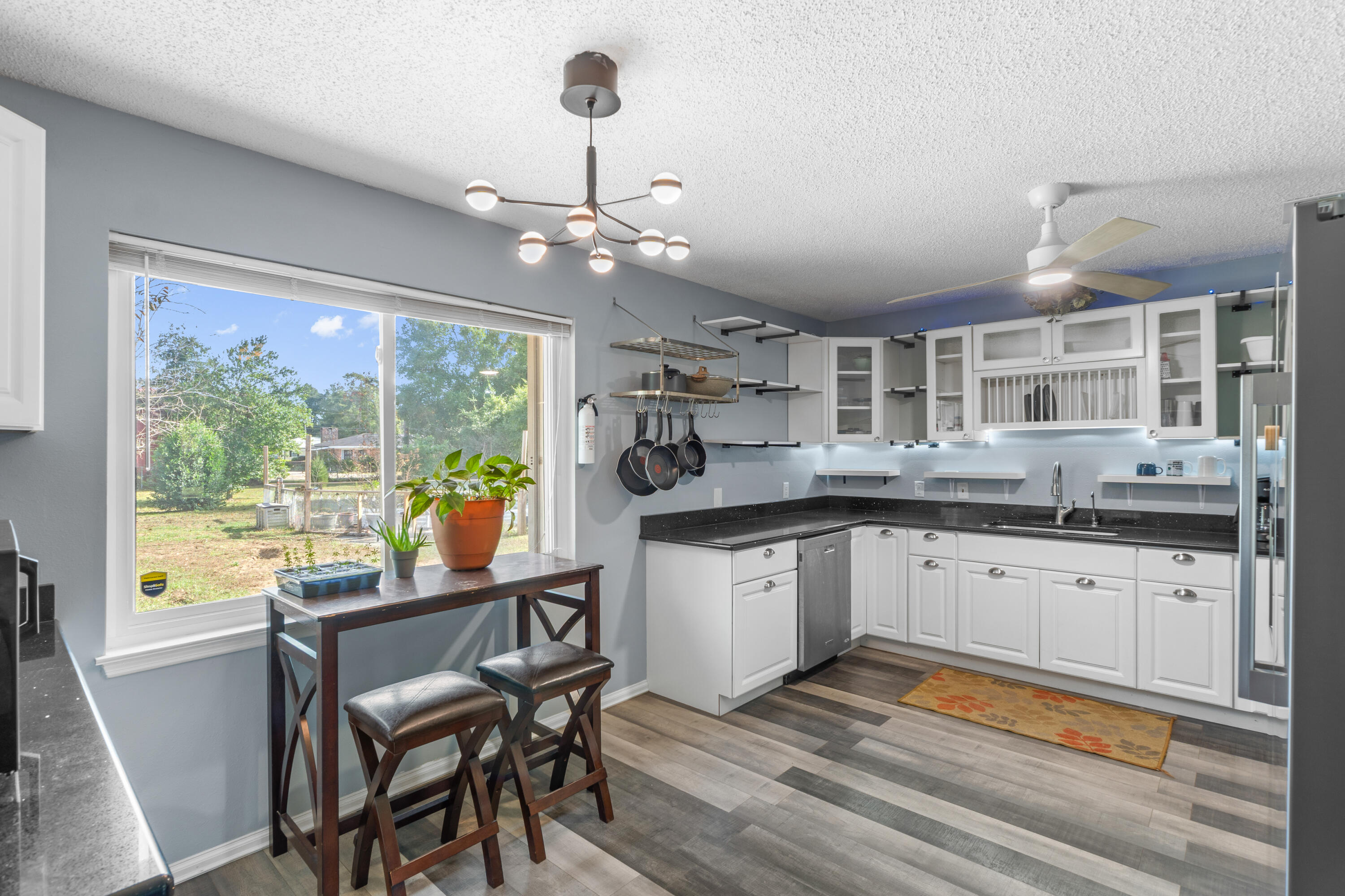 4320 Reinsma Road Milton, FL 32583 - Photo 14 of 41 a kitchen with granite countertop stainless steel appliances a sink and cabinets