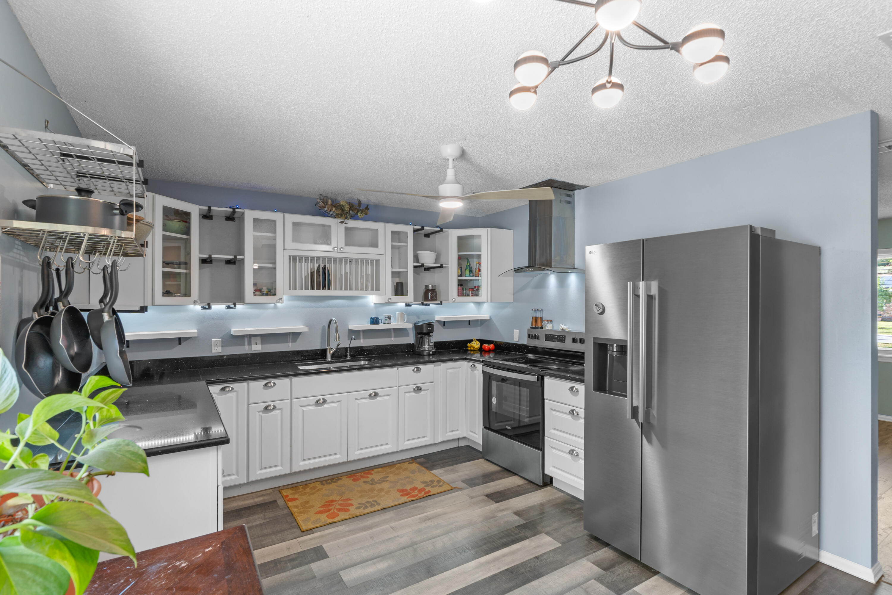 4320 Reinsma Road Milton, FL 32583 - Photo 16 of 41 a kitchen with granite countertop a sink appliances and cabinets