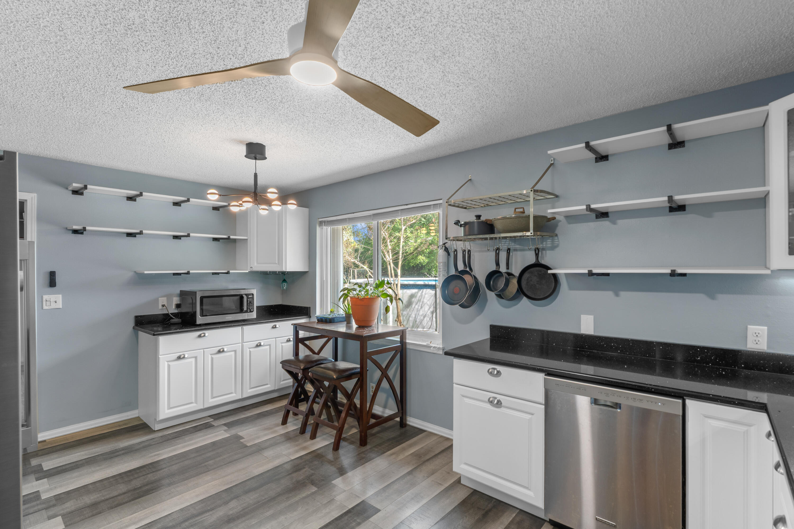 4320 Reinsma Road Milton, FL 32583 - Photo 19 of 41 a kitchen with granite countertop a sink a counter space appliances and cabinets