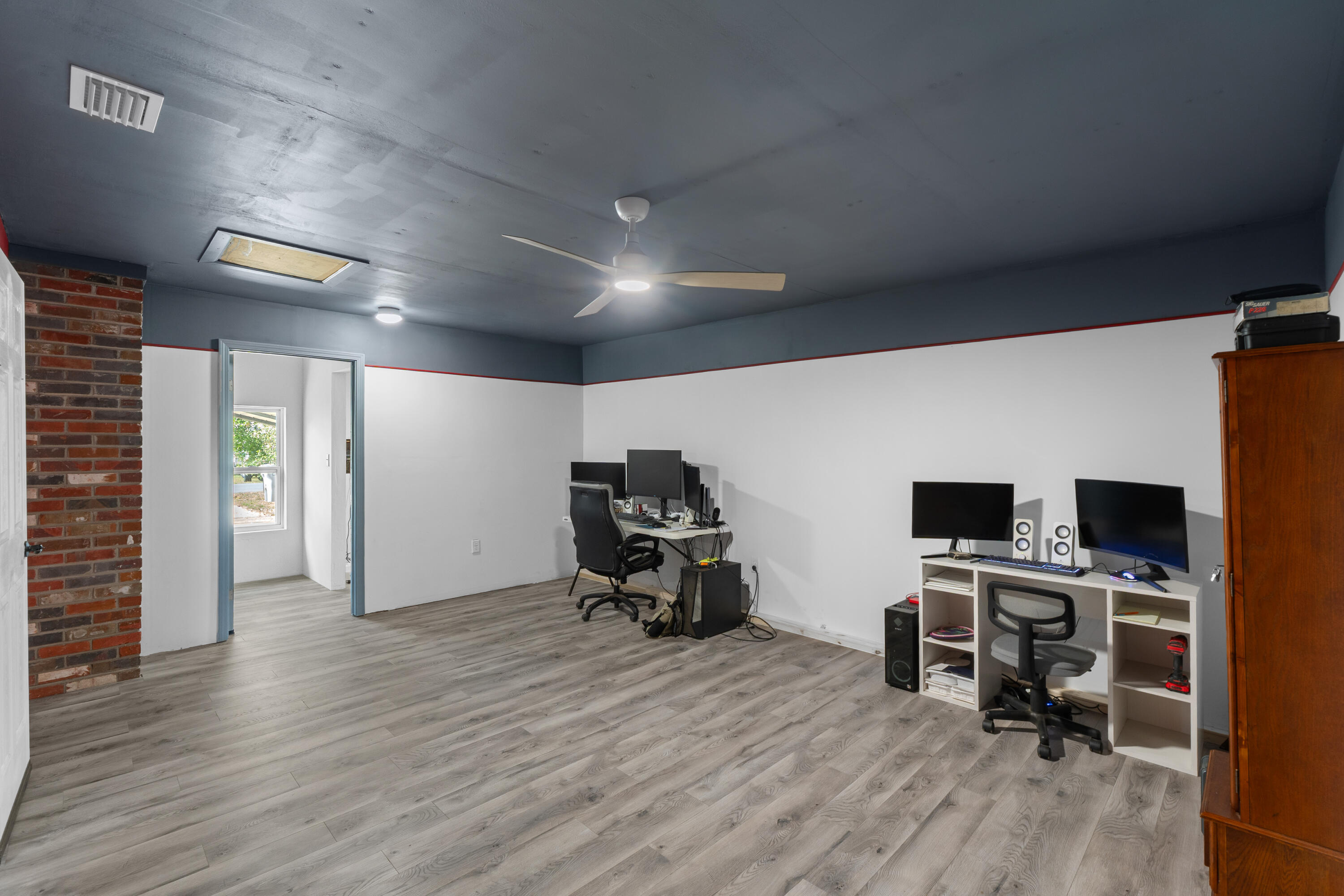 4320 Reinsma Road Milton, FL 32583 - Photo 27 of 41 a view of a workspace with furniture and wooden floor