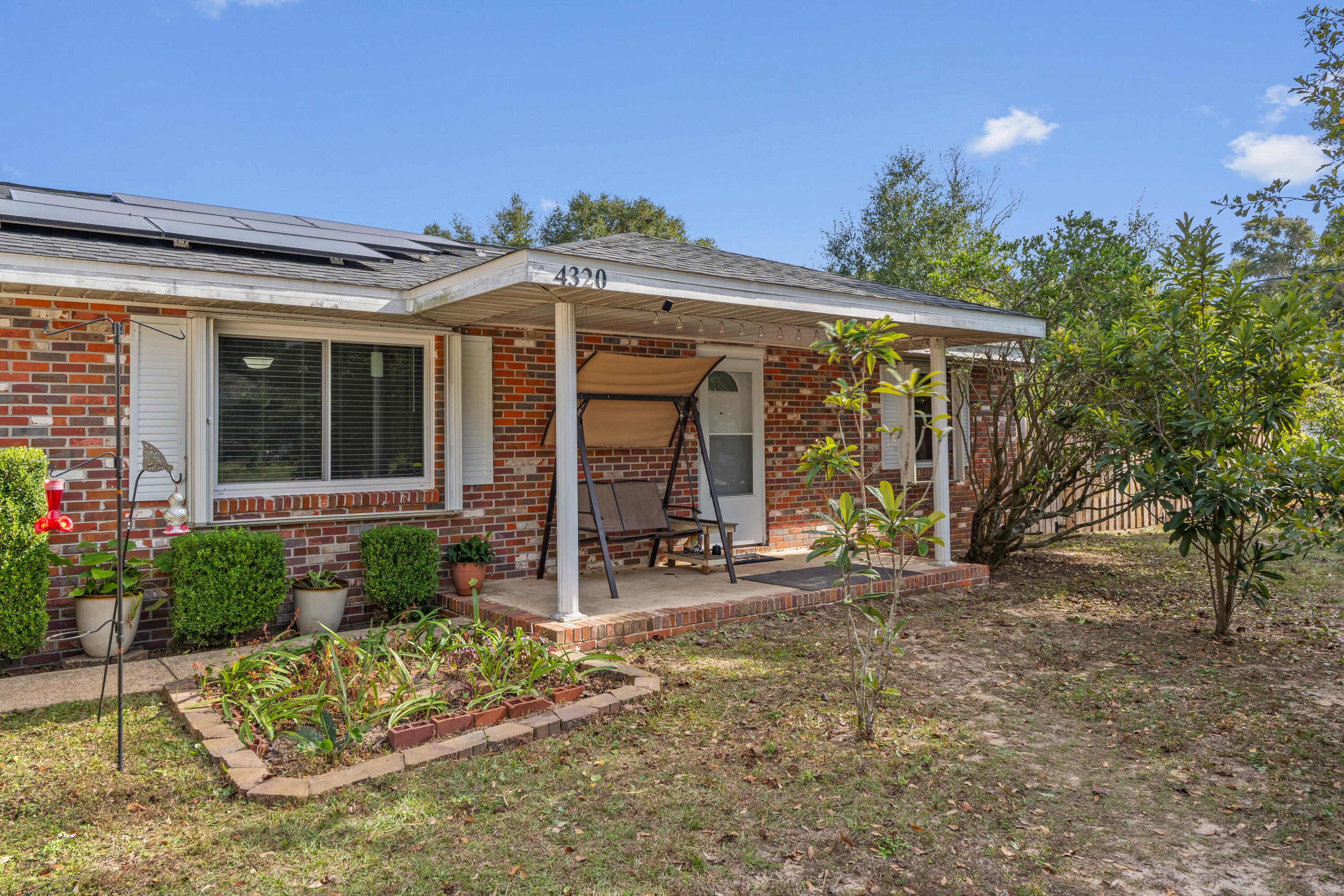 4320 Reinsma Road Milton, FL 32583 - Photo 3 of 41 a front view of a house with garden