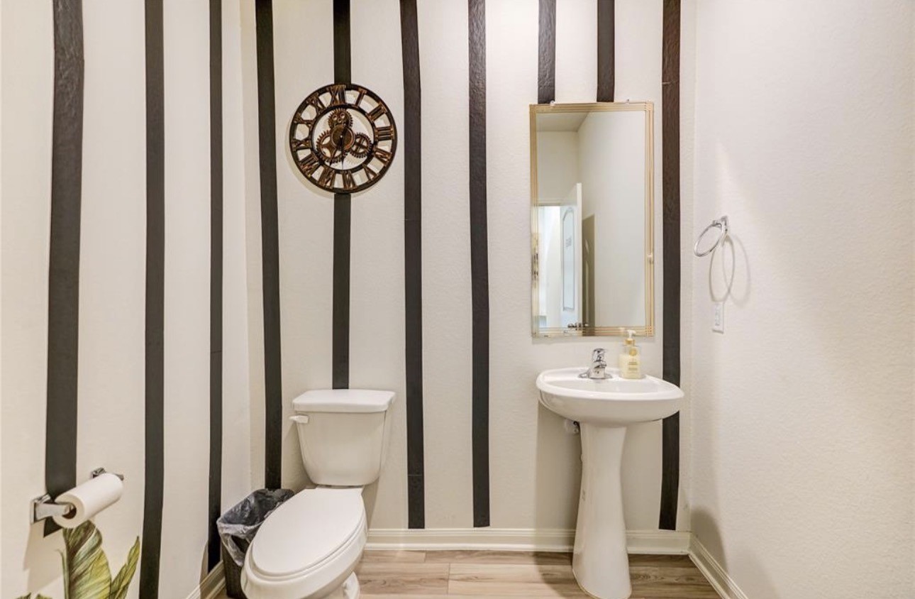 7943 Vacek Meadows Loop Richmond, TX 77469 - Photo 17 of 36 a bathroom with a toilet a sink and mirror