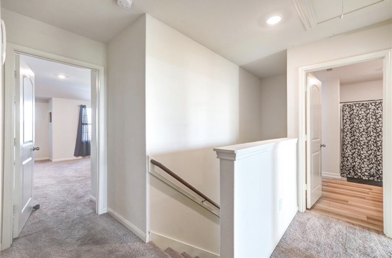 7943 Vacek Meadows Loop Richmond, TX 77469 - Photo 19 of 36 a view of a hallway with bathroom and wooden floor