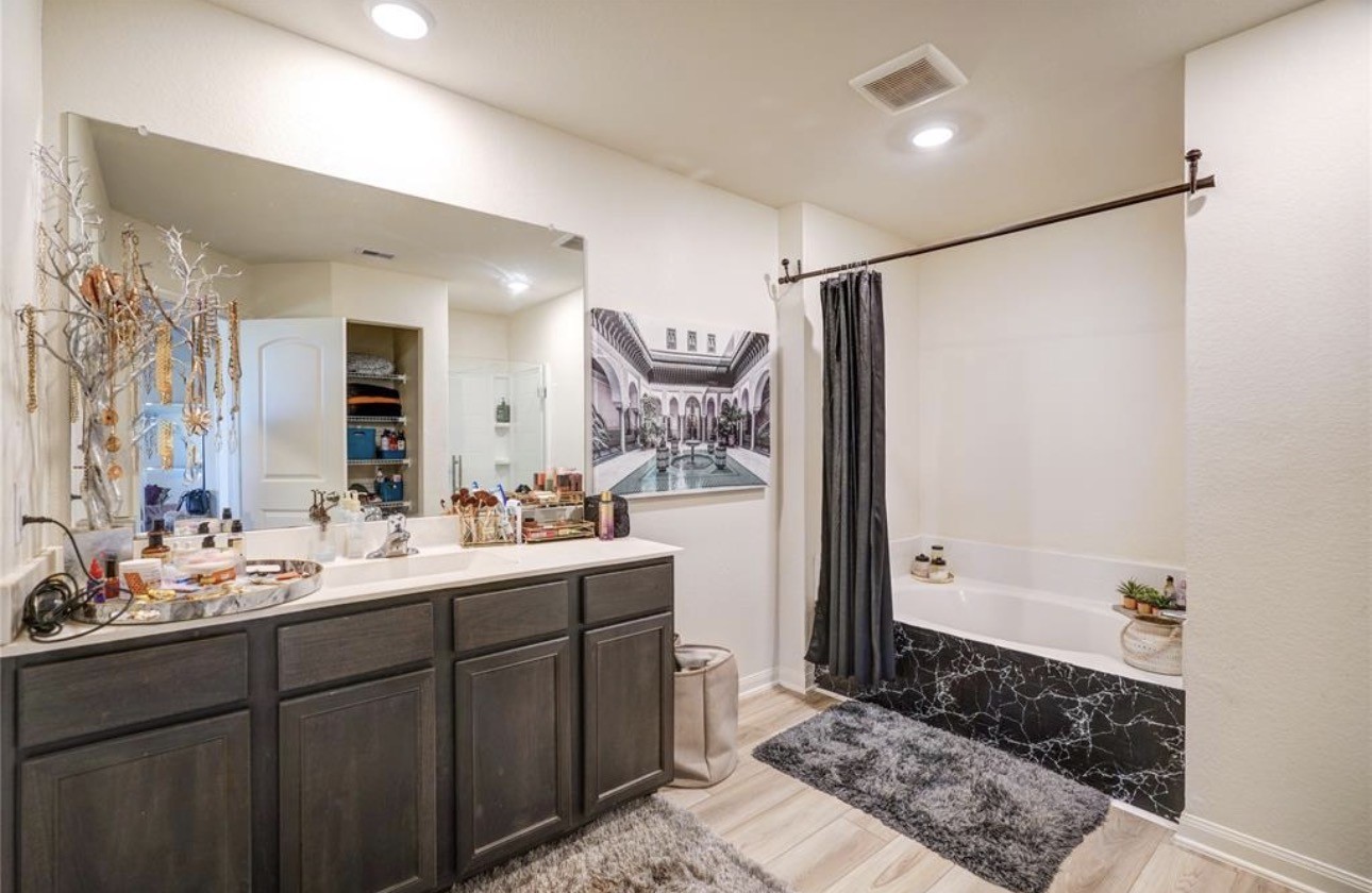 7943 Vacek Meadows Loop Richmond, TX 77469 - Photo 28 of 36 a bathroom with a double vanity sink mirror and bathtub