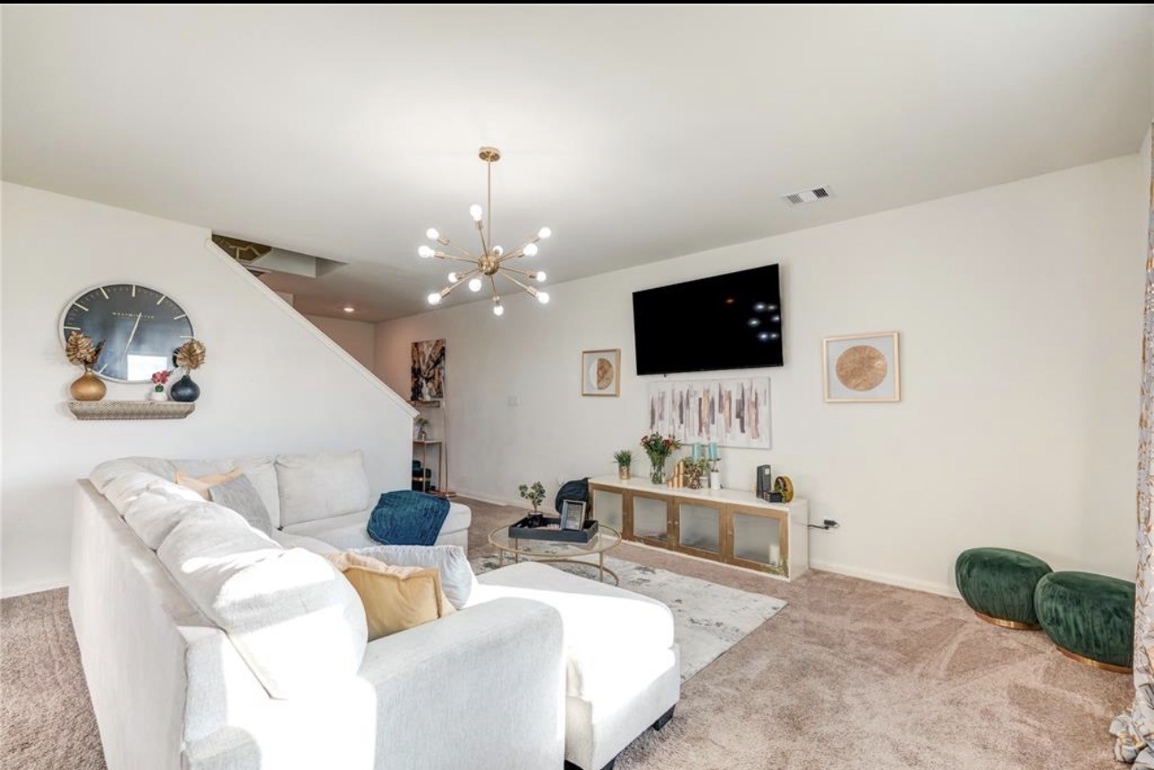 7943 Vacek Meadows Loop Richmond, TX 77469 - Photo 6 of 36 a living room with furniture and a flat screen tv