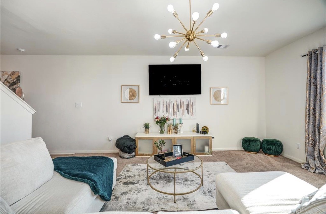 7943 Vacek Meadows Loop Richmond, TX 77469 - Photo 7 of 36 a living room with furniture a flat screen tv and a lamp