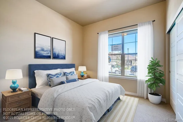a bedroom with a large bed and a potted plant