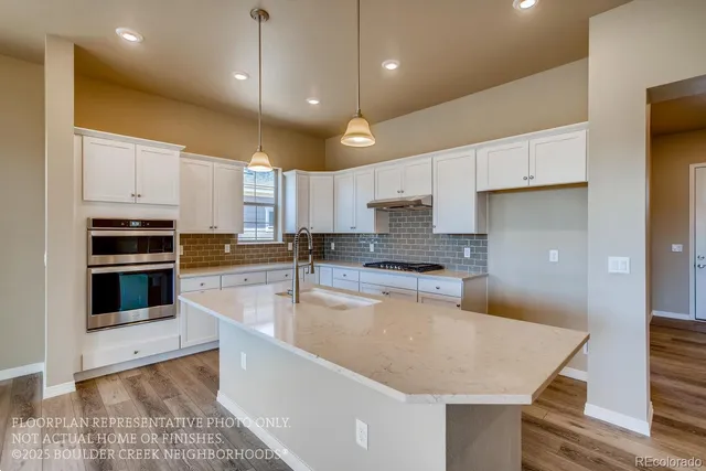 a large kitchen with kitchen island a sink stainless steel appliances and cabinets