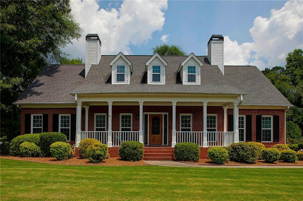 a front view of a house with garden and porch
