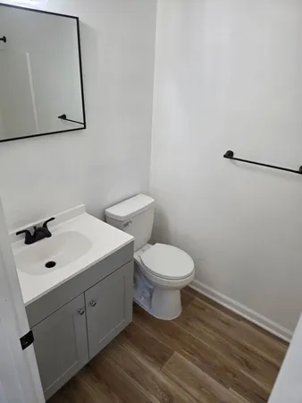 a white toilet sitting next to a bathroom sink