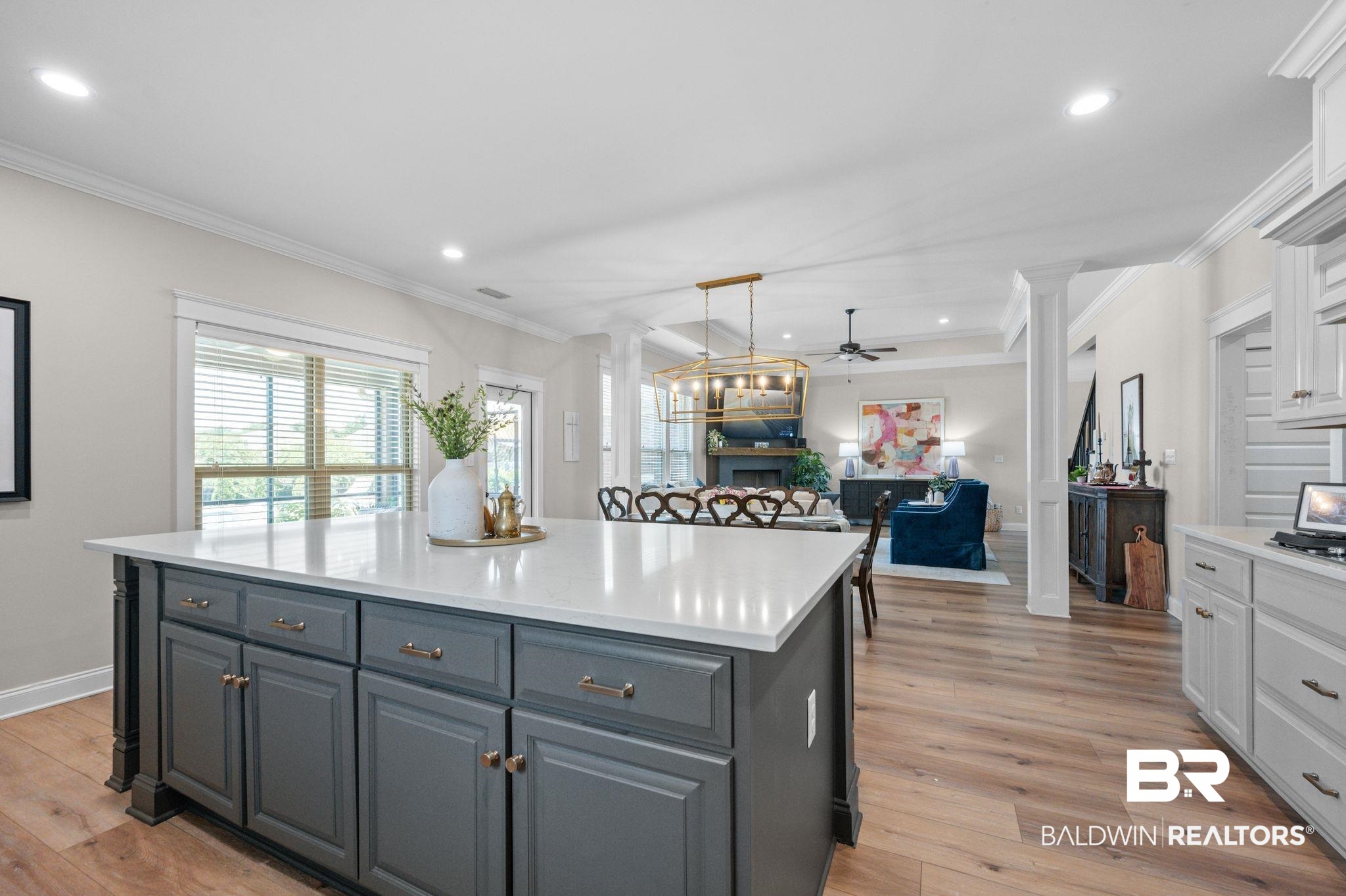 409 Fortune Drive Fairhope, AL 36532 - Photo 14 of 42 Kitchen island featuring a light-toned countertop, gray cabinetry, and brass hardware