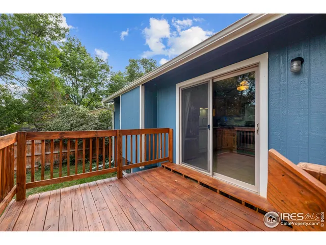 a view of backyard with a deck and wooden floor