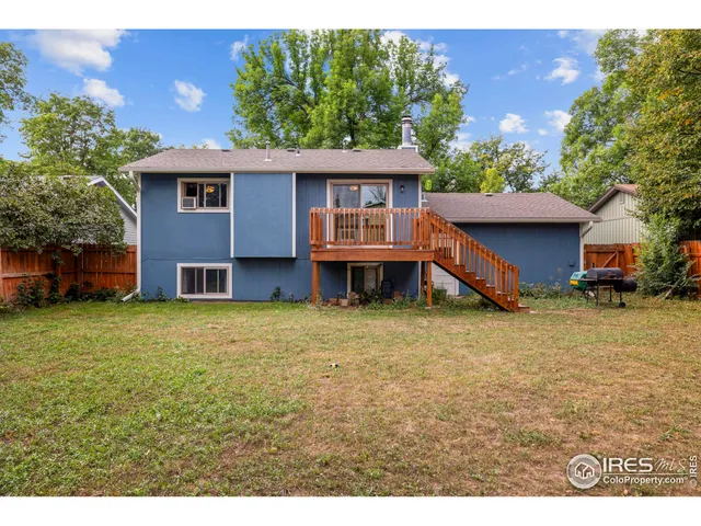 a view of a house with a garden and deck