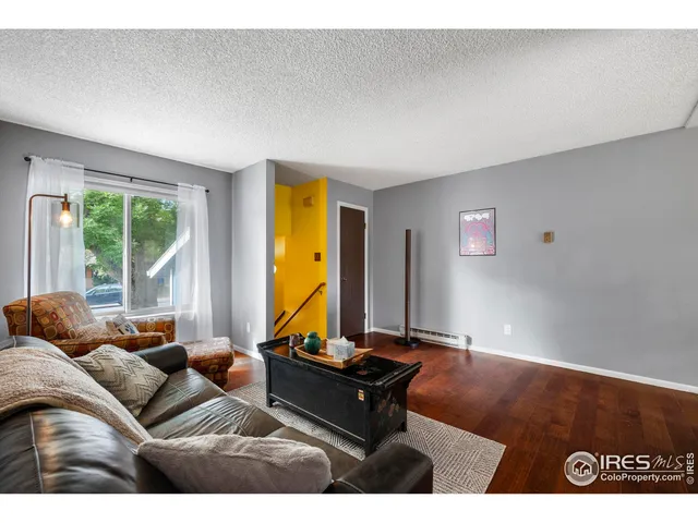 a living room with furniture gym equipment and a large window