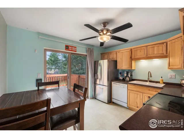 a kitchen with stainless steel appliances granite countertop a stove a refrigerator a sink and a dining table with the view of kitchen