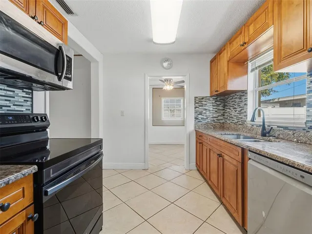a kitchen that has a sink and a stove