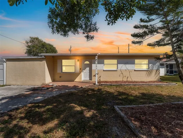 a view of a yard with wooden fence