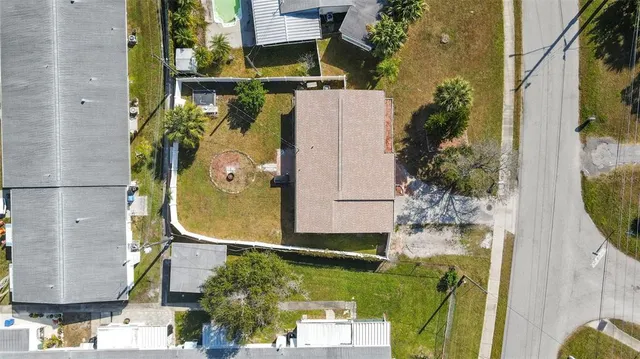 an aerial view of a house with a swimming pool