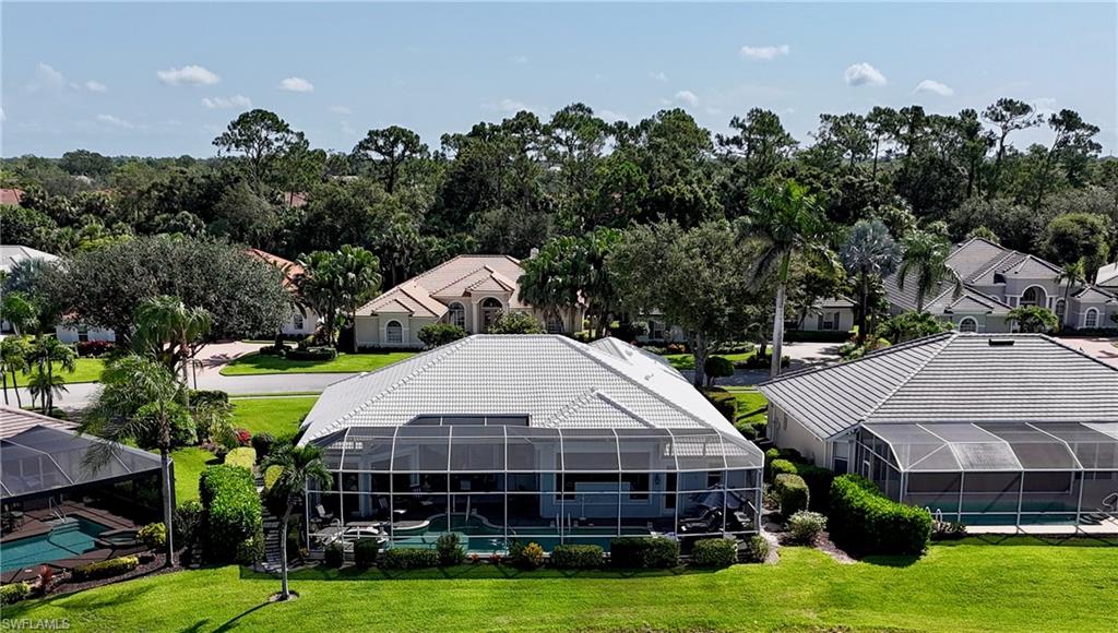1624 Manchester Court Naples, FL 34109 - Photo 12 of 30 a view of a house with swimming pool and green space