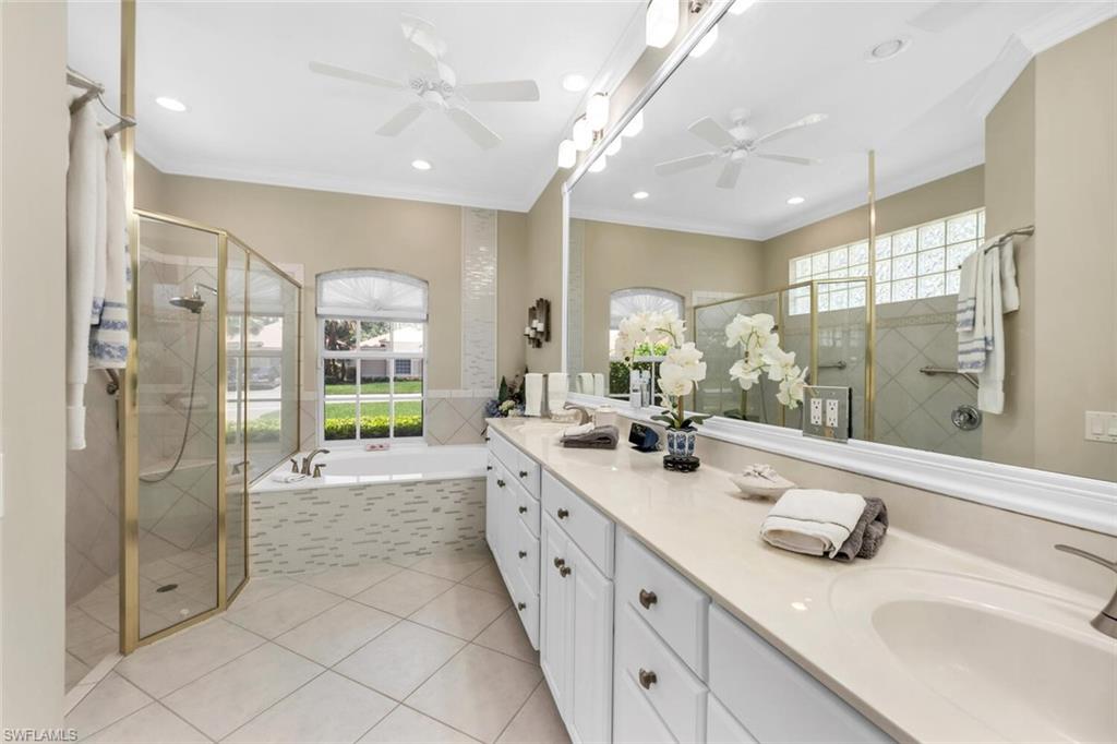 1624 Manchester Court Naples, FL 34109 - Photo 16 of 30 a bathroom with double vanity and a shower