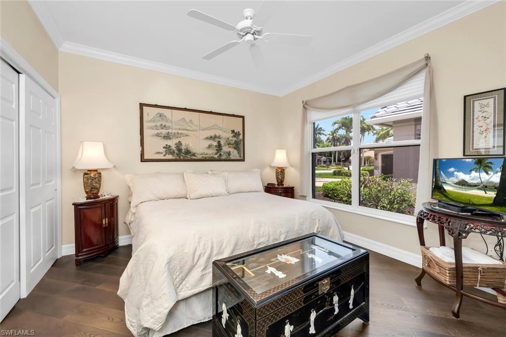 1624 Manchester Court Naples, FL 34109 - Photo 17 of 30 a bedroom with a bed and a flat screen tv