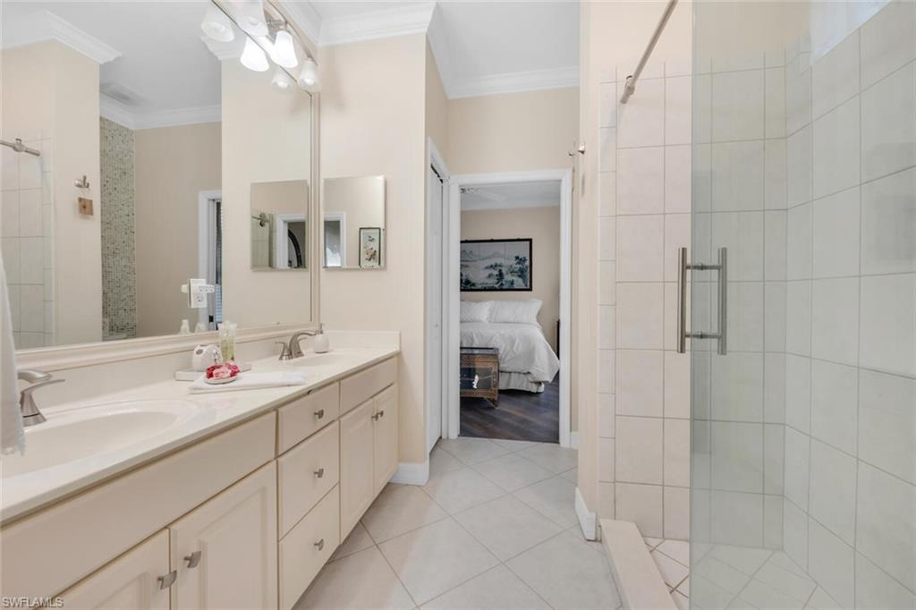1624 Manchester Court Naples, FL 34109 - Photo 18 of 30 a en suite bathroom with a double sink and mirror