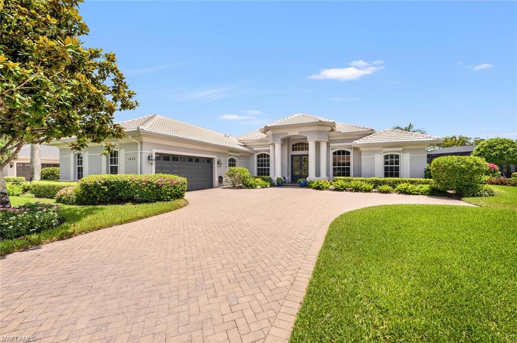 1624 Manchester Court Naples, FL 34109 - Photo 2 of 30 a front view of a house with a yard
