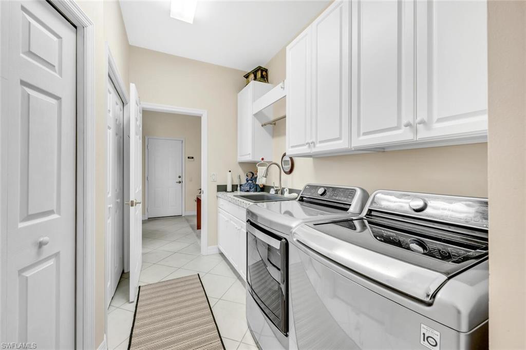 1624 Manchester Court Naples, FL 34109 - Photo 22 of 30 a kitchen with appliances cabinets and a sink