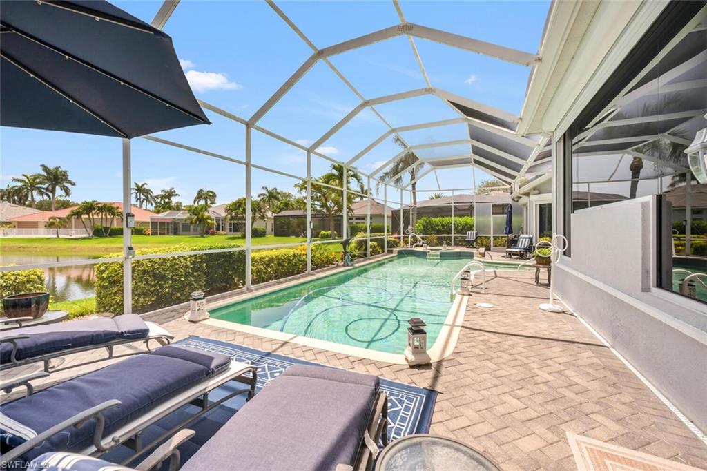 1624 Manchester Court Naples, FL 34109 - Photo 24 of 30 a view of a patio with a table and chairs under an umbrella