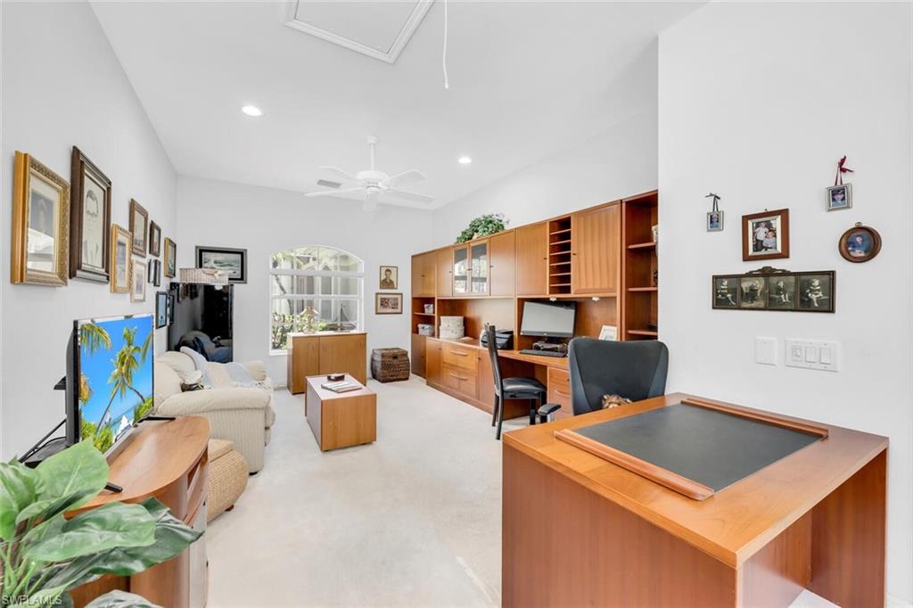 1624 Manchester Court Naples, FL 34109 - Photo 26 of 30 a living room with furniture and a flat screen tv