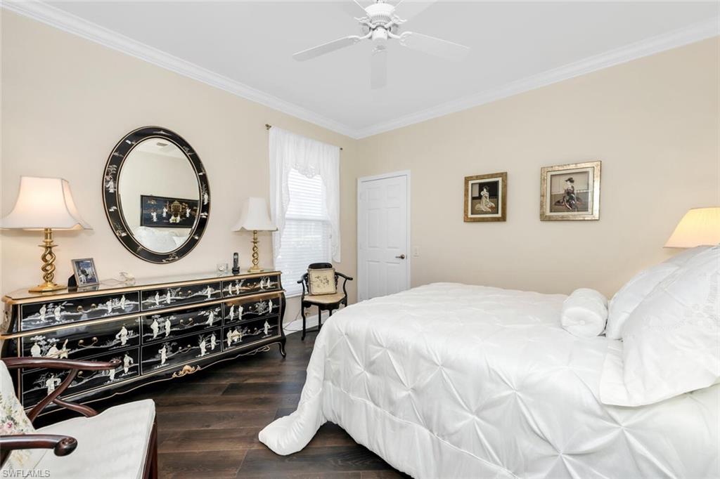 1624 Manchester Court Naples, FL 34109 - Photo 29 of 30 a bedroom with a bed and a chandelier