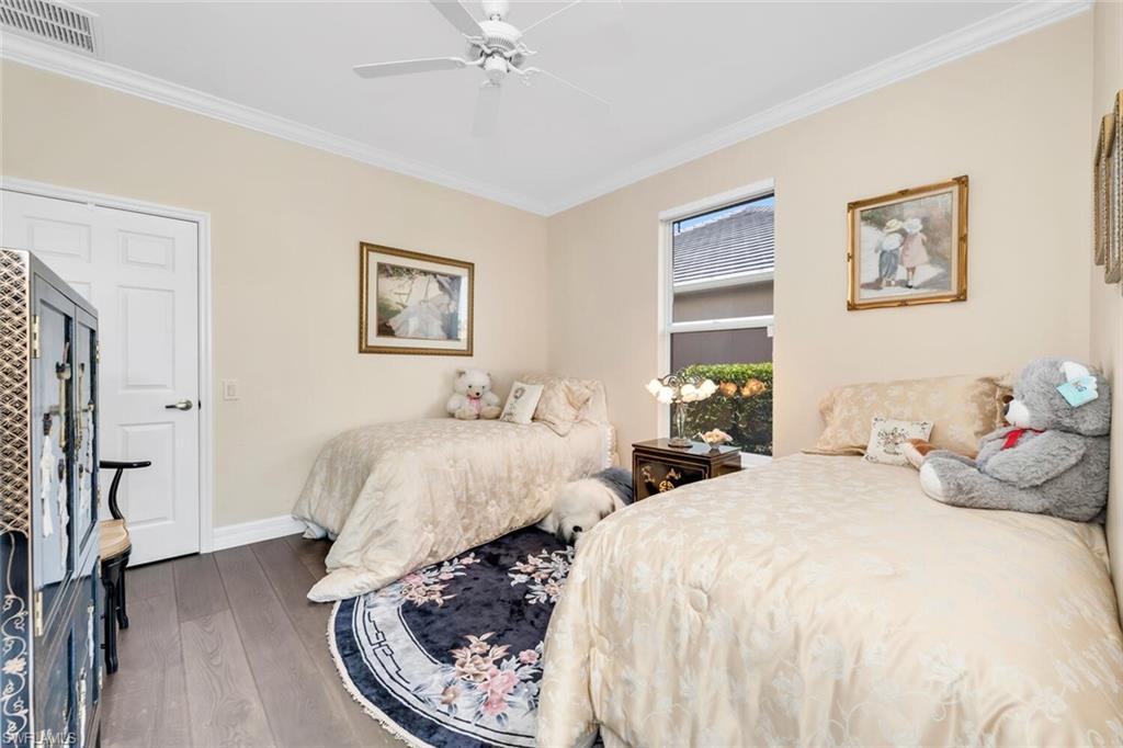1624 Manchester Court Naples, FL 34109 - Photo 30 of 30 a bedroom with two beds and a chandelier