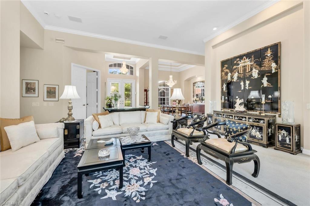 1624 Manchester Court Naples, FL 34109 - Photo 4 of 30 a living room with furniture wooden floor and a large window